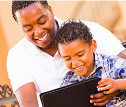 father and son working on a tablet