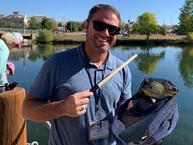 Picture of a man catching a fish with a jiggle stick