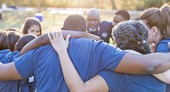 People in a circle supporting one another.