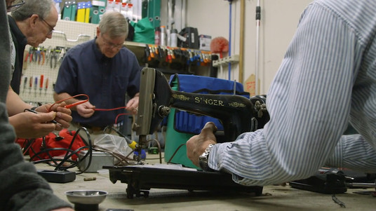 The Fixers Collective at work fixing a sewing machine