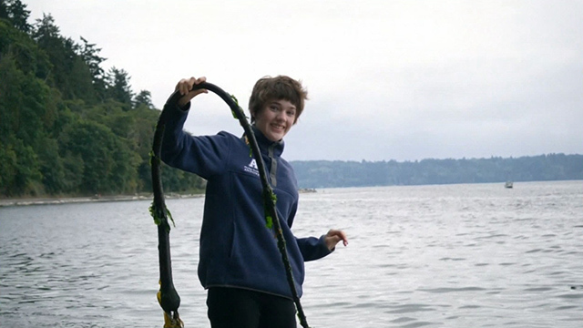 Aria Erickson holds up some kelp